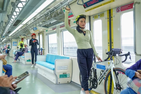 Penumpang berdiri sambil membawa sepeda di dalam gerbong kereta LRT saat melintas di kawasan Dukuh Atas, Jakarta, Rabu (13/05/2026