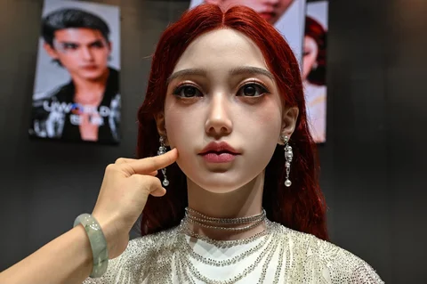 Seorang wanita menyentuh wajah robot humanoid selama peluncuran robot humanoid U1 yang diproduksi oleh UWORLD, sebuah merek di bawah UBTECH Robotics, di Shenzhen, provinsi Guangdong, Tiongkok, Selasa (30/06/2026).
