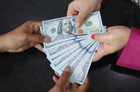 Karyawan menghitung mata uang Dolar AS di VIP Money Changer, Jakarta, Jumat (05/06/2026).