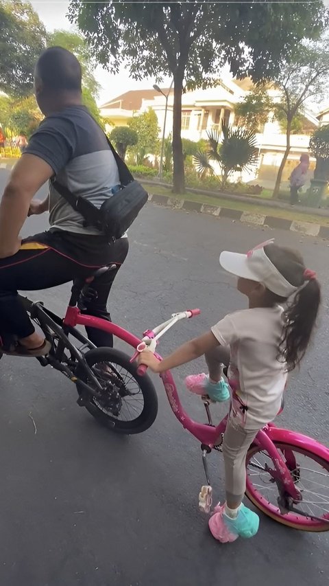 So Sweet, Father Rides His Bike with His Daughter's Pink Bike