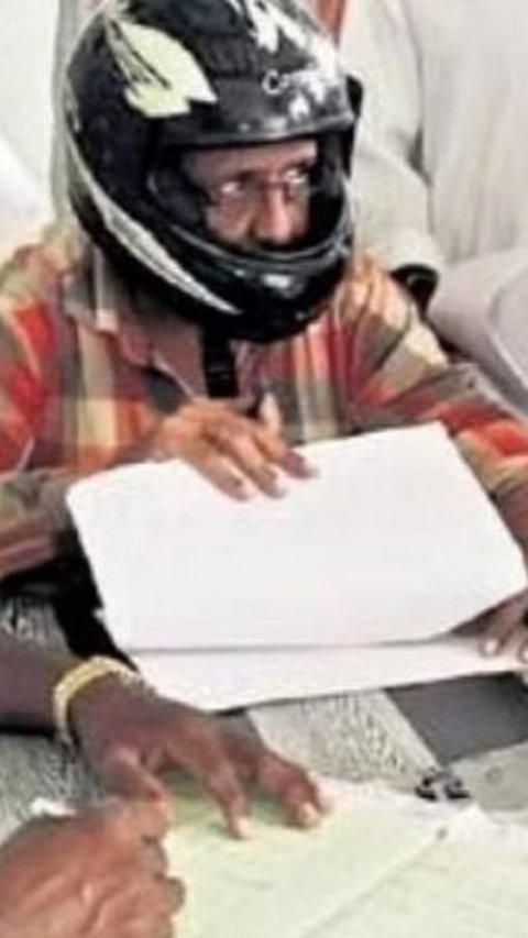 Staff in an Indian Office Wearing Helmets for Fear of Ceiling Collapsing