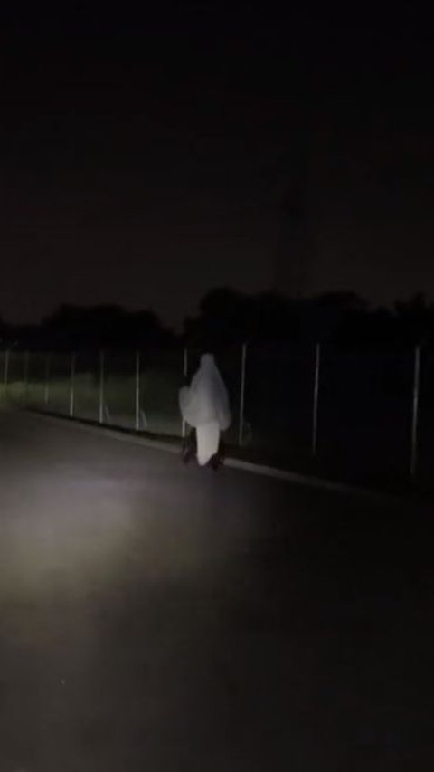 The Moment of a White Figure Floating in the Dark Road, Revealed from Up Close