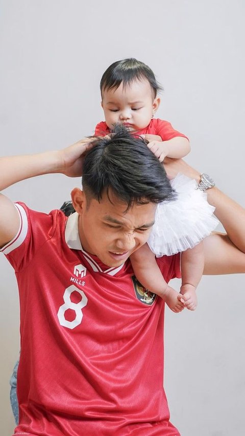 Portrait of Witan Sulaiman and His Son Having a Photoshoot Wearing the National Team Jersey, Called Baby Carrying Baby