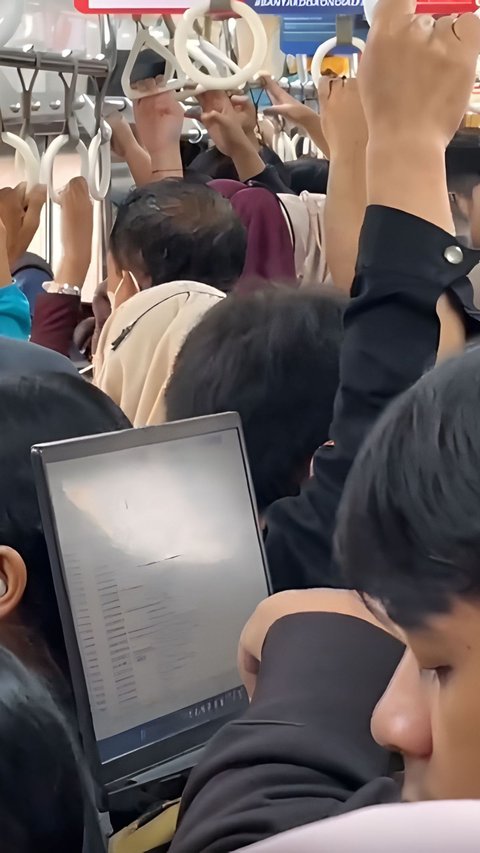 Rare View in Train Carriage, Passengers Still Working with Laptop While Standing in a Crowded Train