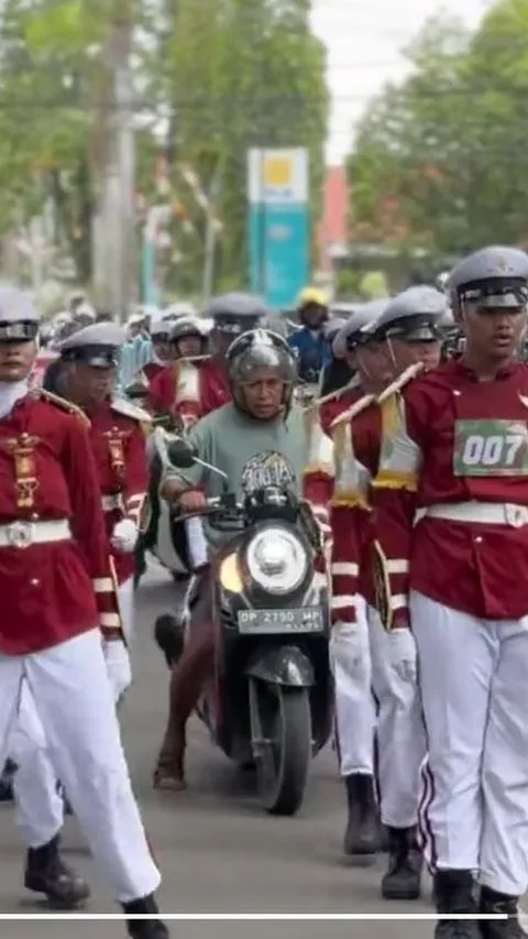 Setelah melanggar barisan pasukan Gerak Jalan, seorang pemotor menjadi viral karena terjebak di tengah mereka.