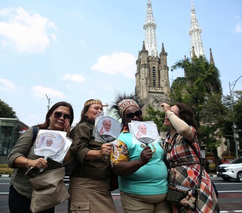 Sejumlah masyarakat saat menanti kedatangan Paus Fransiskus yang akan mengunjungi Gereja Katedral, Jakarta, Rabu (4/9/2024). Paus Fransiskus dijadwalkan mengunjungi Gereja Katedral dalam rangkaian kegiatannya selama di Indonesia. Foto: Liputan6.com/Angga Yuniar