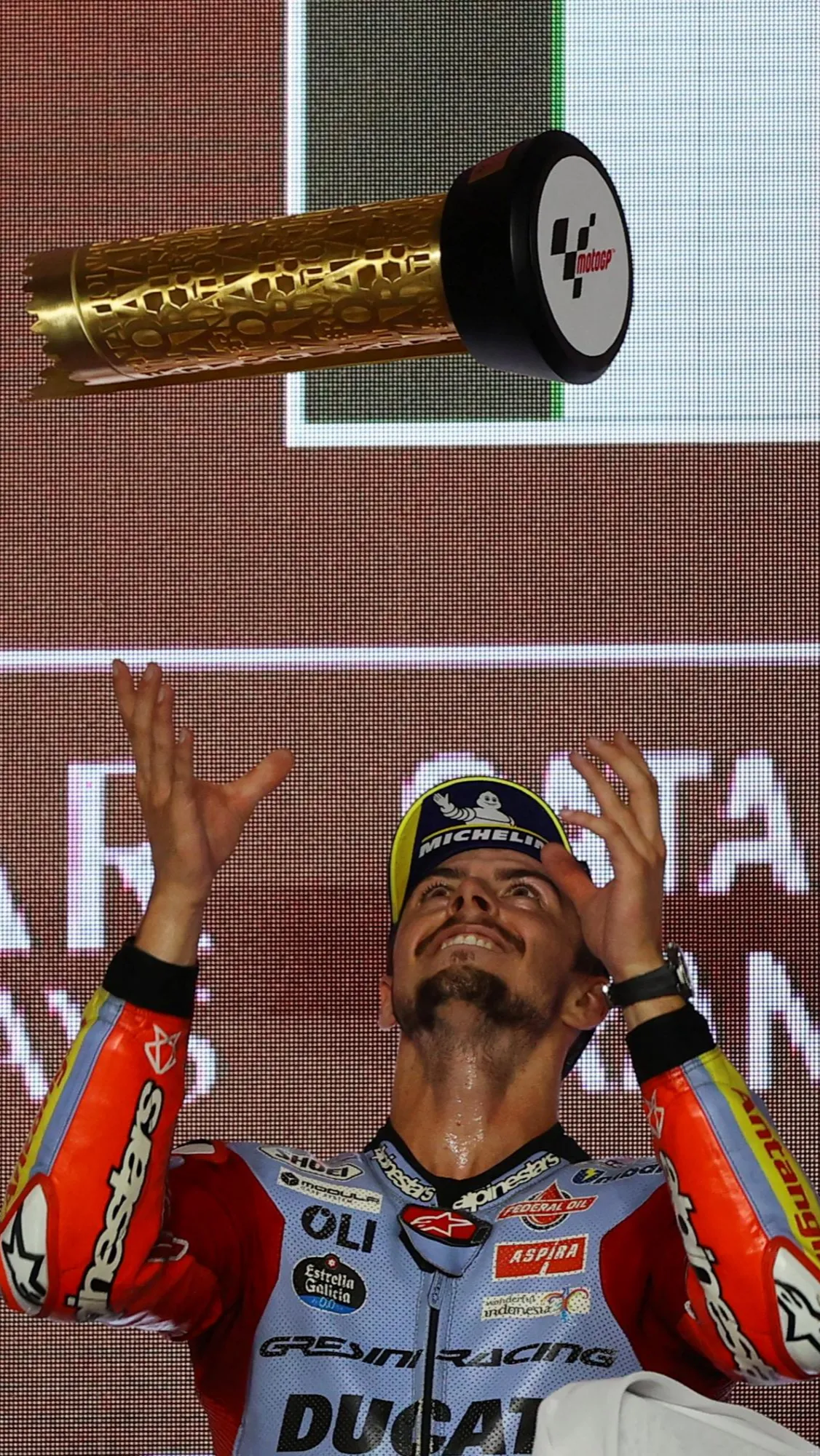 Fabio Di Giannantonio saat rayakan kemenangannya di podium pertama MotoGP.