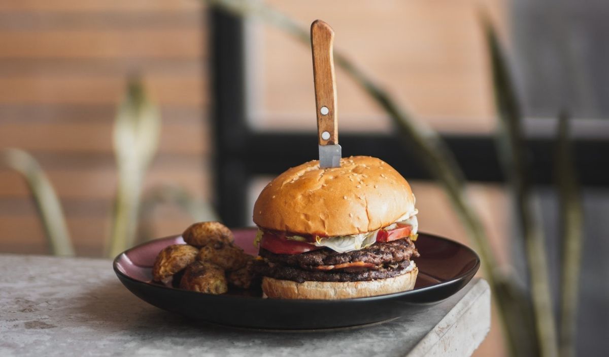 9. Place the top halves of the buns on the assembled burgers. Serve your classic Smash Burgers immediately while they're hot, and enjoy your tasty classic Smash burger!