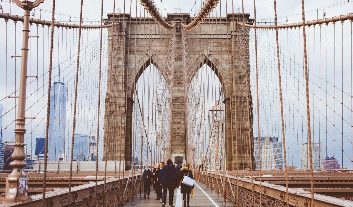 You can walk across the bridge by using the Brooklyn Bridge Pedestrian Walkway and enjoy the beautiful view of Brooklyn, Manhattan, and the East River from the bridge.