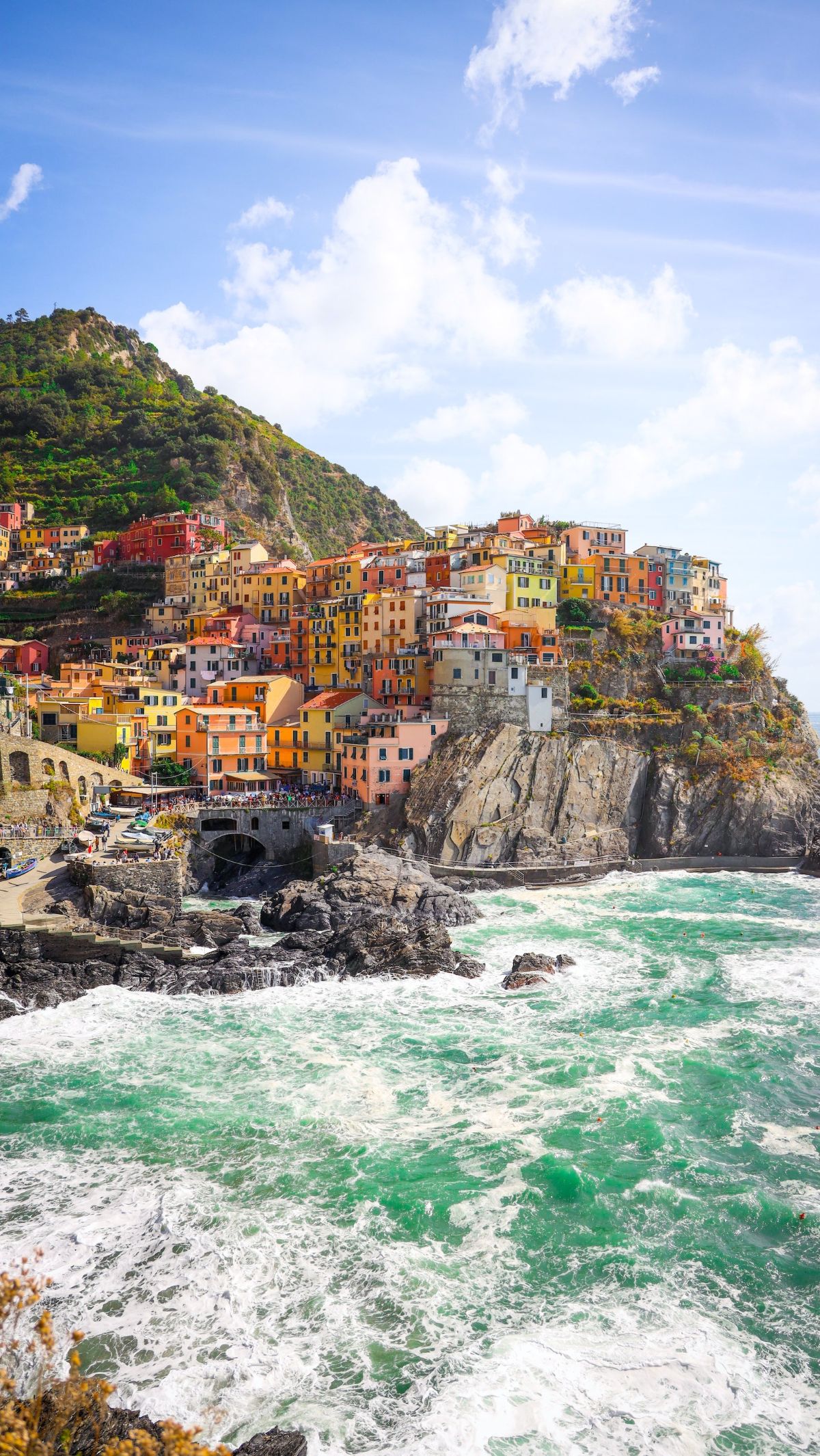 5. Manarola: Cinematic Splendor<br><br>Manarola is one of the Cinque Terre villages in Italy. It is a postcard-perfect vision of colorful houses perched on cliffs. These are overlooking the Ligurian Sea. The sun's embrace turns the buildings into a rich symphony of shades.<br><br>Photo: pexels-evan-cameron-