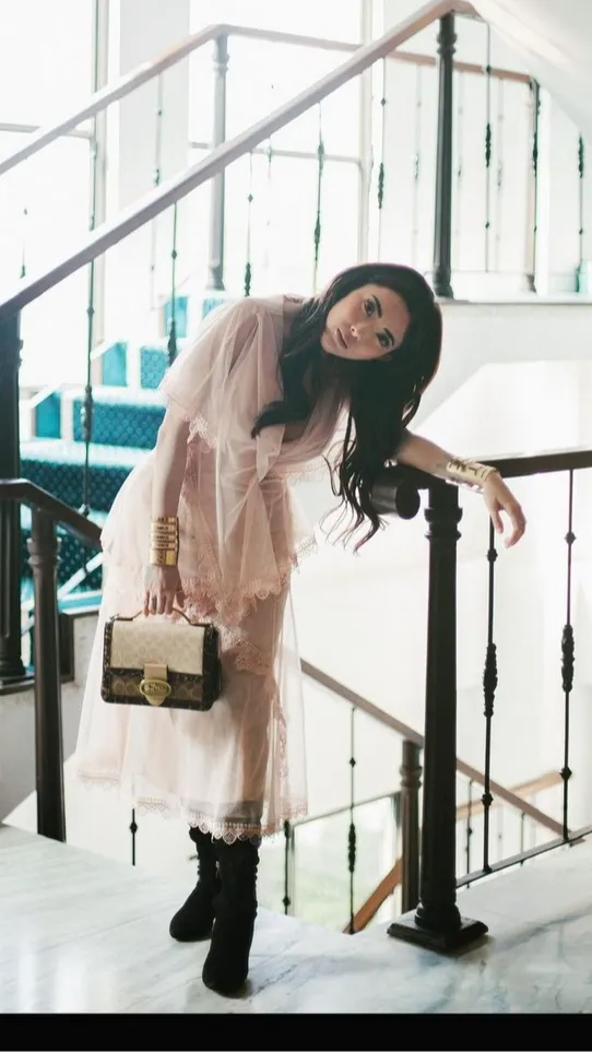 Wanita 29 tahun ini tampil feminim dengan gaun transparan.