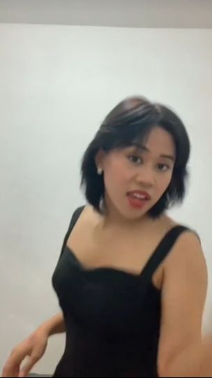 Penampilannya semakin berbeda dengan penggunaan dress berwarna hitam yang simpel