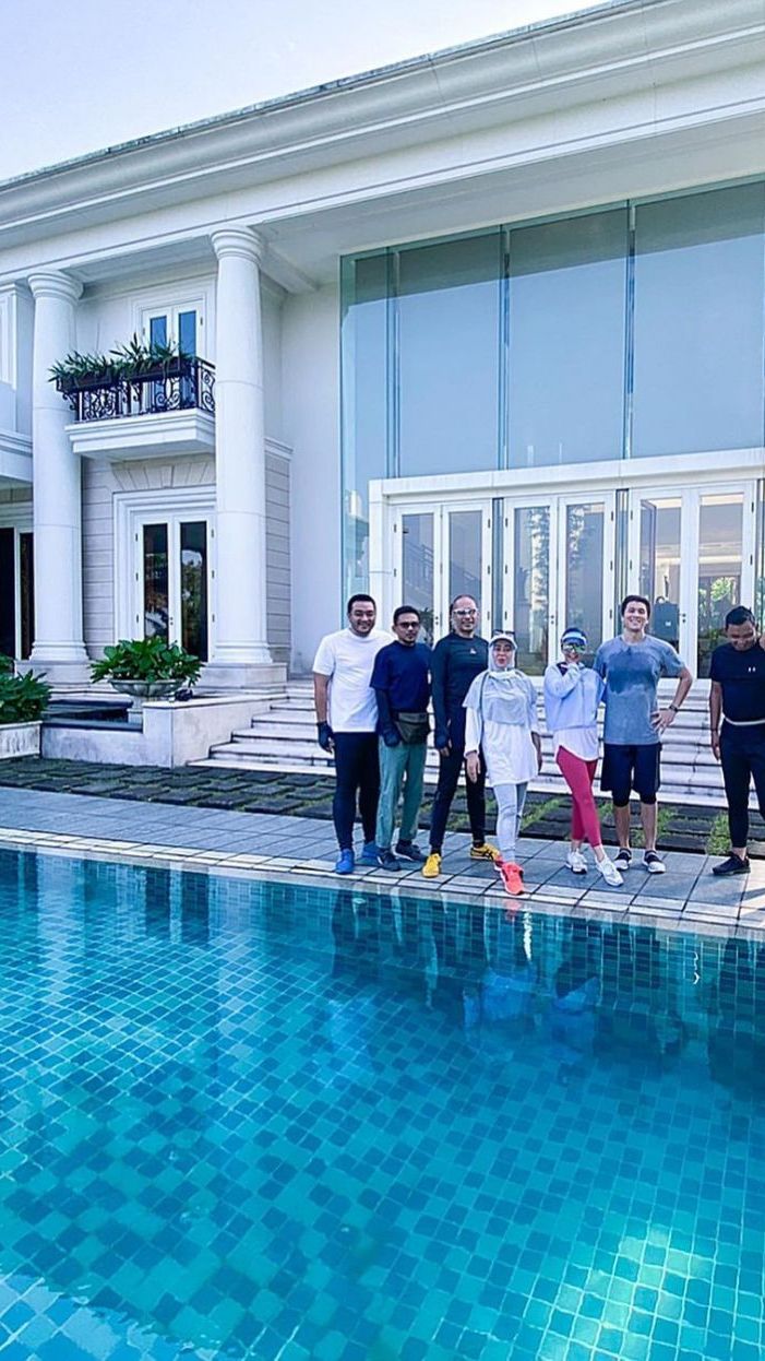 Ada kolam renang besar di samping rumah yang sangat mewah.