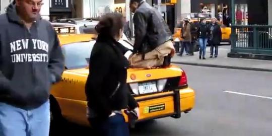 Pria salat di atas taksi di New York