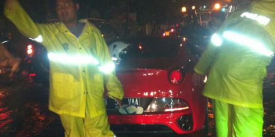 Ferrari merah mogok di tengah genangan air