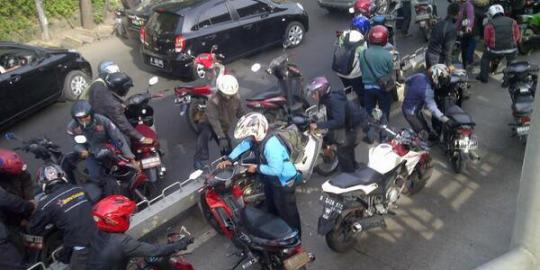 Takut polisi, pemotor gotong royong angkat motor di jalur Transj