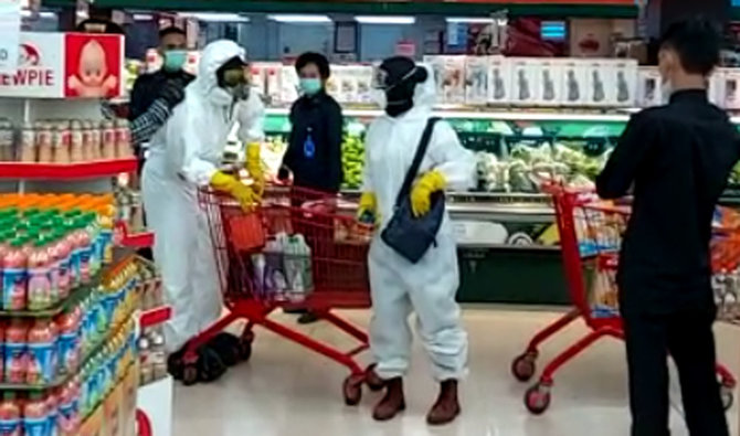 warga belanja di supermarket pakai baju hazmat