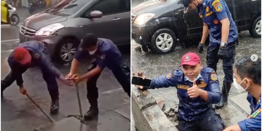 Viral Petugas Damkar Selamatkan HP yang Tercebur Got saat Hujan, Aksinya Tuai Pujian