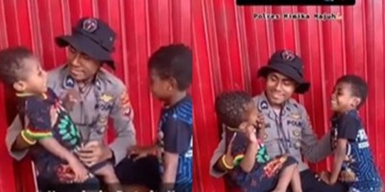 Di Momen HUT Bhayangkara Ke-76, Polisi Ini Gendong Anak Papua dengan Tersenyum