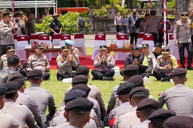 momen kapolri duduk bersila di atas rumput