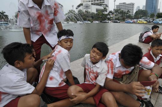 Aksi murid SD corat-coret seragam di Bundaran HI