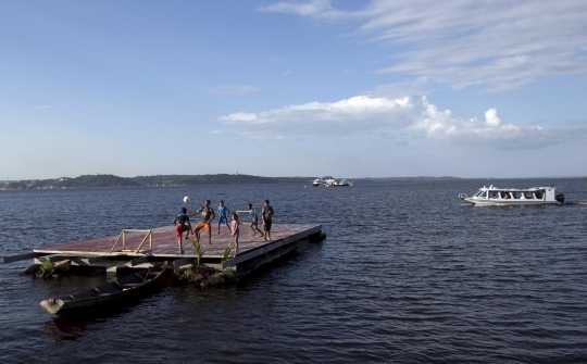 Keceriaan bocah Brasil main bola di atas Sungai Hitam Amazonas