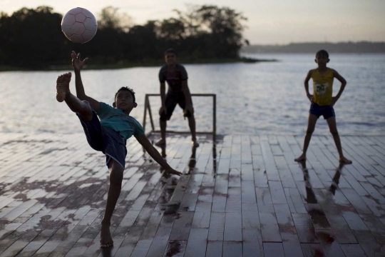 Keceriaan bocah Brasil main bola di atas Sungai Hitam Amazonas