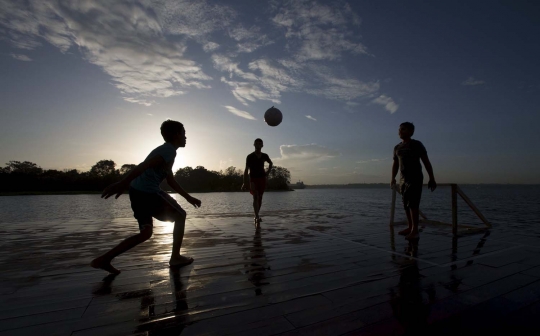 Keceriaan bocah Brasil main bola di atas Sungai Hitam Amazonas