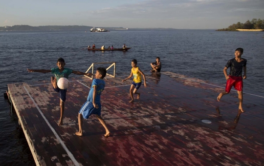 Keceriaan bocah Brasil main bola di atas Sungai Hitam Amazonas