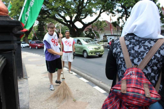 Datang dari AS, bule ganteng & cantik ini jadi tukang sapu di Malang