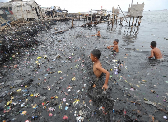 Keceriaan anak-anak Muara Angke berenang di pantai penuh sampah