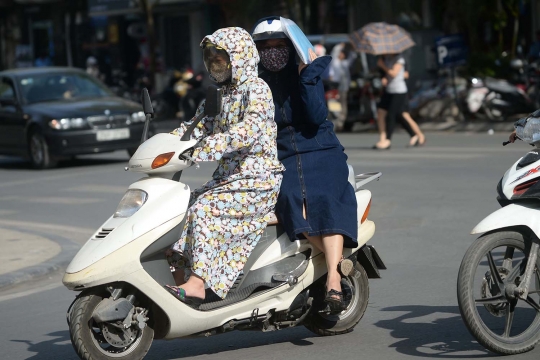 Cara unik warga Vietnam hindari panas saat naik motor