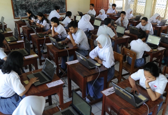 Keseriusan murid SMA mengikuti Ujian Nasional Berbasis Komputer