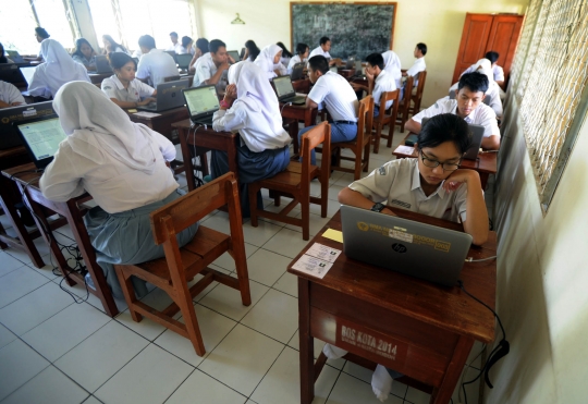 Keseriusan murid SMA mengikuti Ujian Nasional Berbasis Komputer