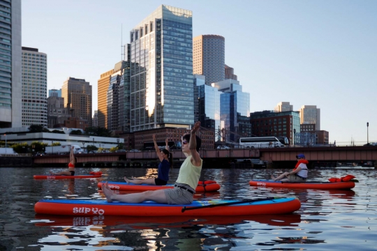 Aksi wanita Amerika Serikat yoga di atas laut