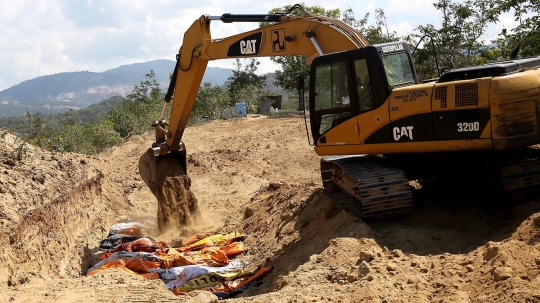 Dibantu eskavator, puluhan korban gempa dan tsunami Palu dikubur massal