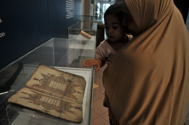 Pengunjung melihat salah satu koleksi mushaf Alquran yang dipamerkan di Museum Bayt Al-Quran, Jakarta, Minggu (19/5). Bayt Al-Quran menyimpan lebih dari 60 mushaf Alquran kuno yang berasal dari berbagai daerah di Nusantara yang dikumpulkan sejak abad ke-16.