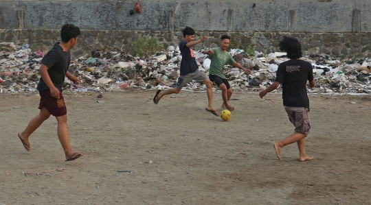 Bermain Sepak Bola di Antara Tumpukan Sampah