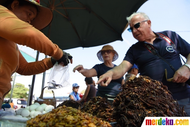 Turis memesan tarantula goreng di Kota Skun, Provinsi Kampong Cham, Kamboja, pada 4 Desember 2019. 