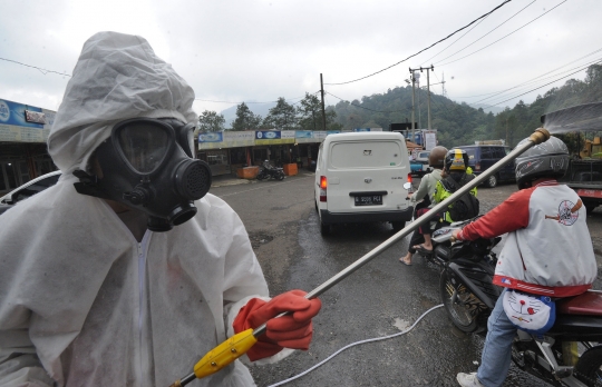 Antisipasi Covid-19, Brimob Sterilisasi Kendaraan di Cianjur