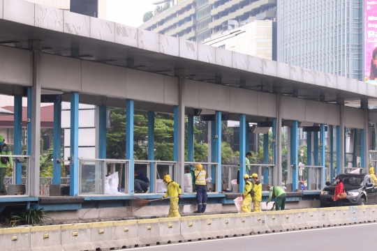 Petugas Bersihkan Sisa Kerusakan Halte Transjakarta