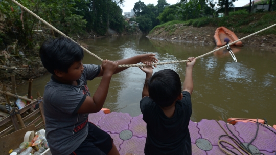 Naik Perahu Eretan Menyeberangi Sungai Ciliwung