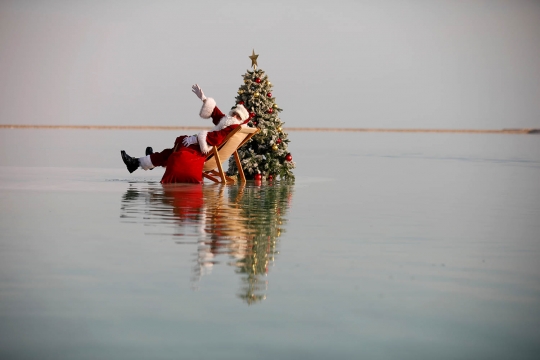 Aksi Sinterklas Duduk Santai di Atas Laut Mati