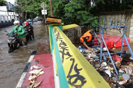 Aksi Petugas UPK Badan Air DLH DKI Bersihkan Sumbatan Sampah di Kali Mampang