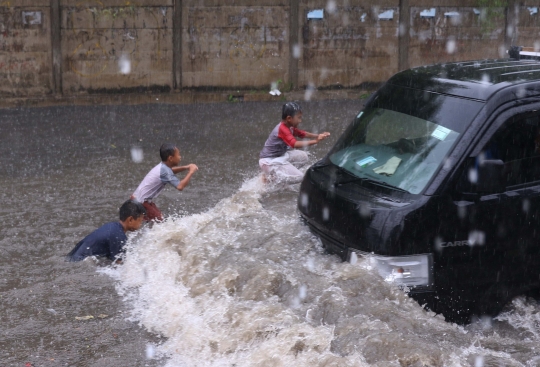 Ketika Banjir Jadi Arena Bermain Anak-Anak