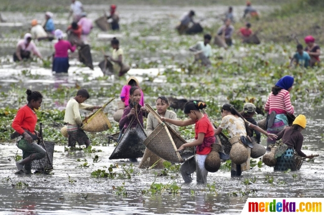 Penduduk desa berpartisipasi dalam acara memancing masyarakat selama perayaan Panen Bhogali Bihu di Danau Goroimari di Panbari, di pinggiran Guwahati, India, Kamis (13/1/2022). Bhogali Bihu merupakan festival panen ikan yang digelar sebagai penanda berakhirnya musim panen.
