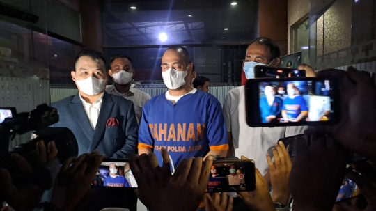 Foto Ferry Irawan dengan Tangan Terikat dan Berbaju Biru Bertulis Tahanan