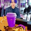 Ada sosok Jungkook BTS yang diedit duduk santai di Mcd dengan warna rambut ungunya yang matching dengan BTS Meal.