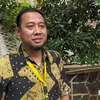 Pengacara Andre Taulany berdiri di bawah pohon