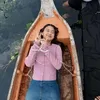 Esta Pramanita santai saat berada di atas sampan